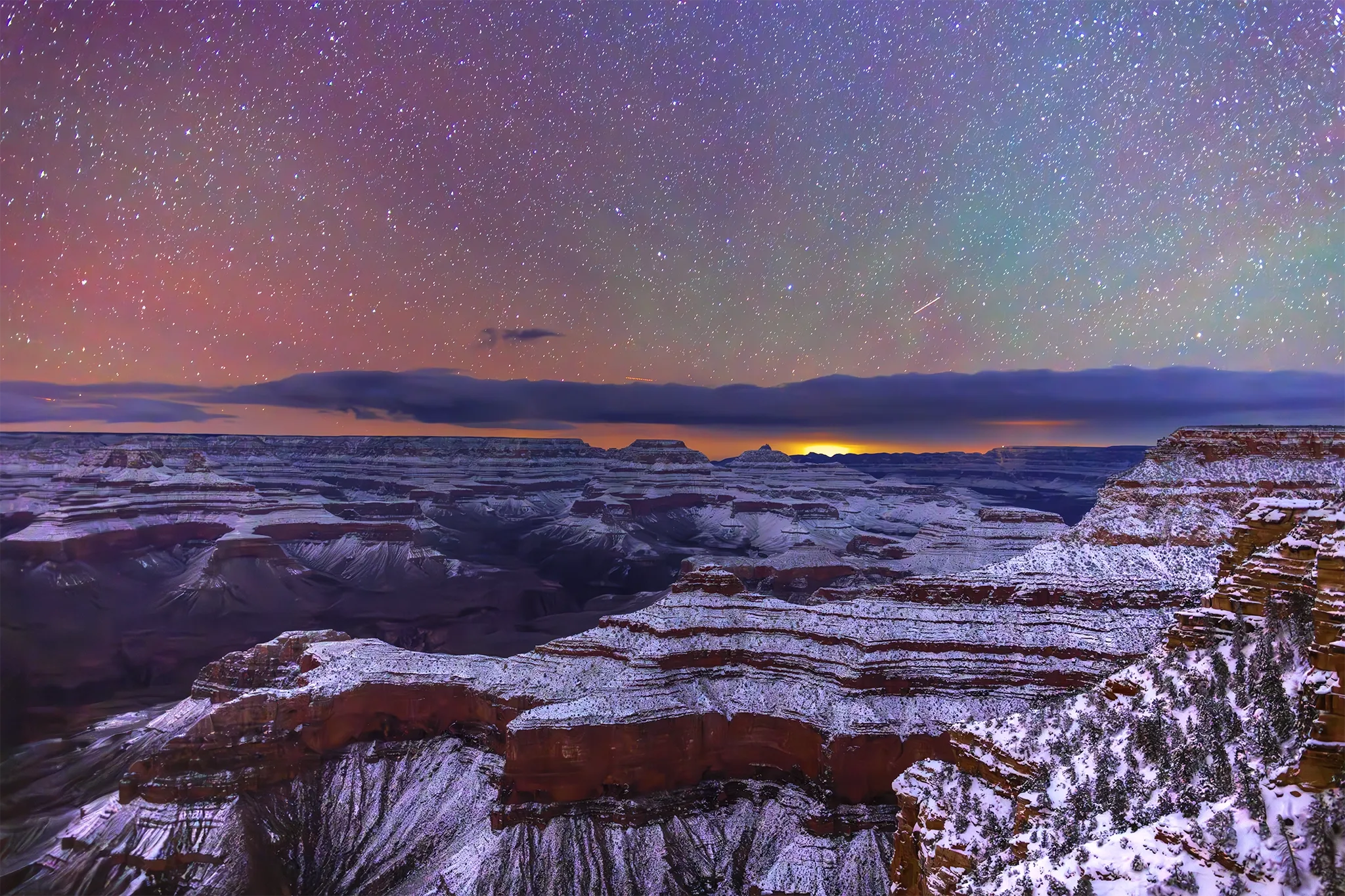 A view of Starlight and Snow at Mather Point in Grand Canyon National Park, AZ on the Mather Point Trail at night in Winter.