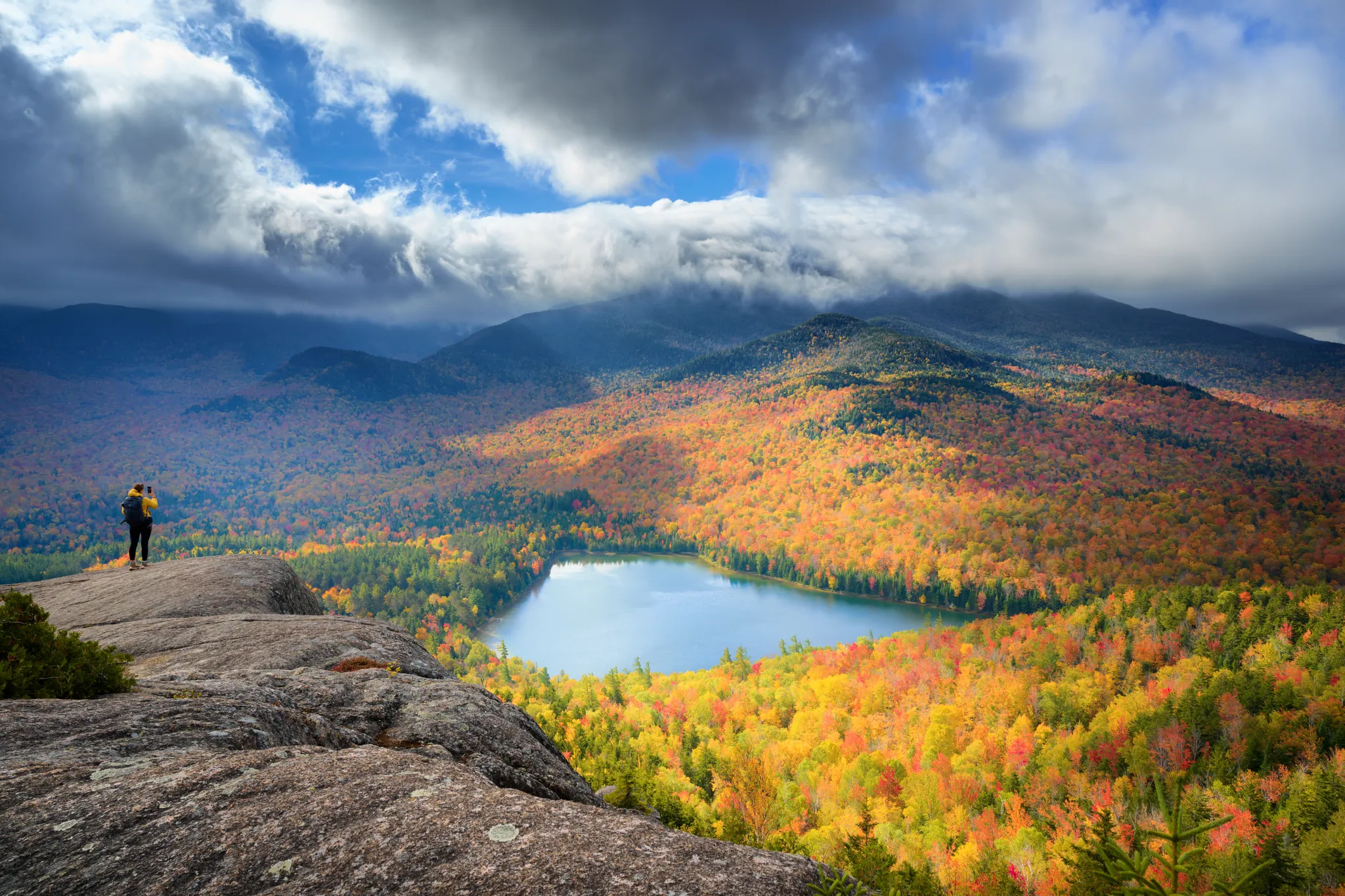 A view of Sunbeams and Autumn Fire from Mount Jo featuring Heart Lake in Adirondack Mountains, NY on the Mount Jo Trail during the morning in Autumn.